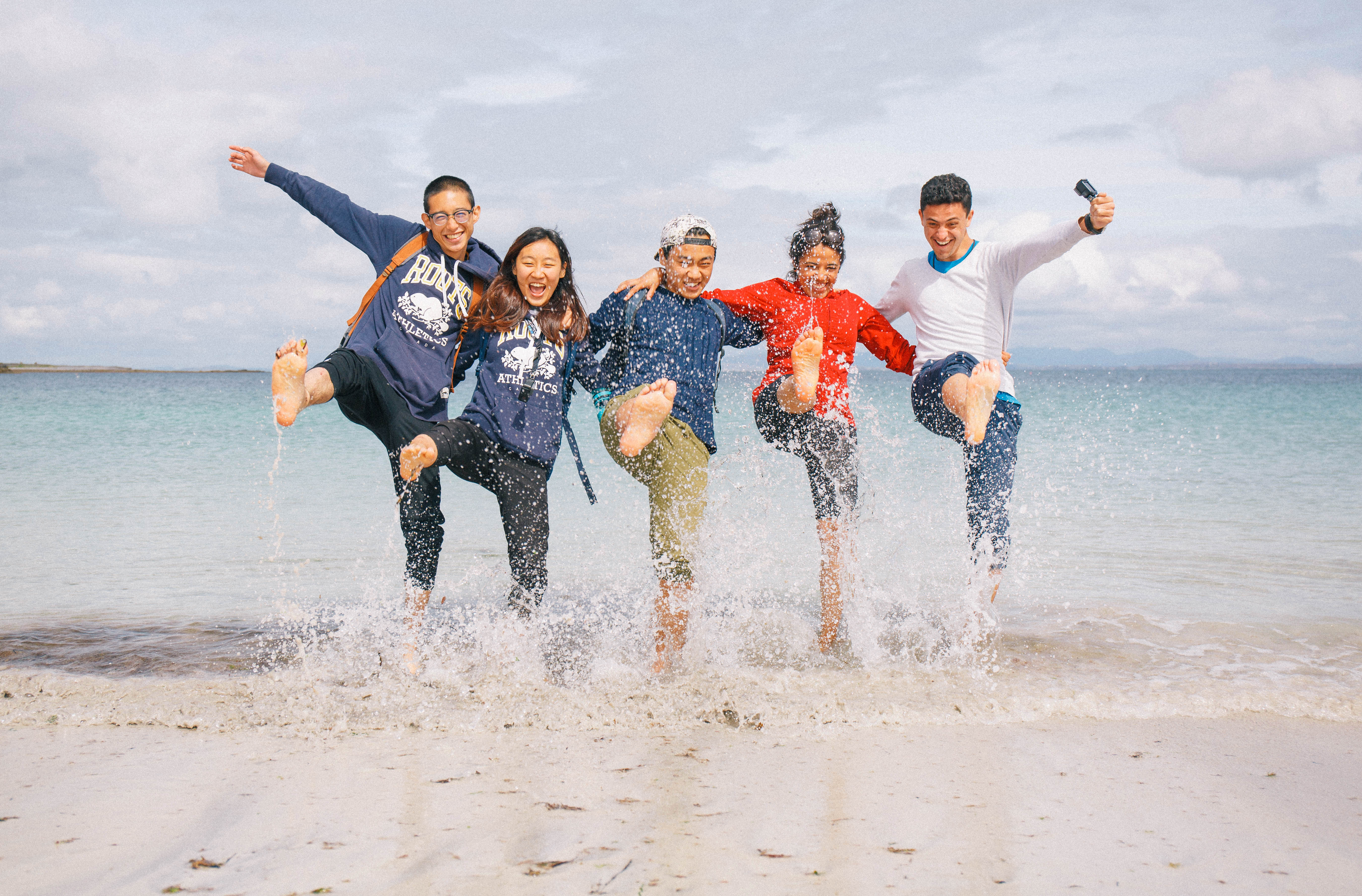 Students splashing water beach