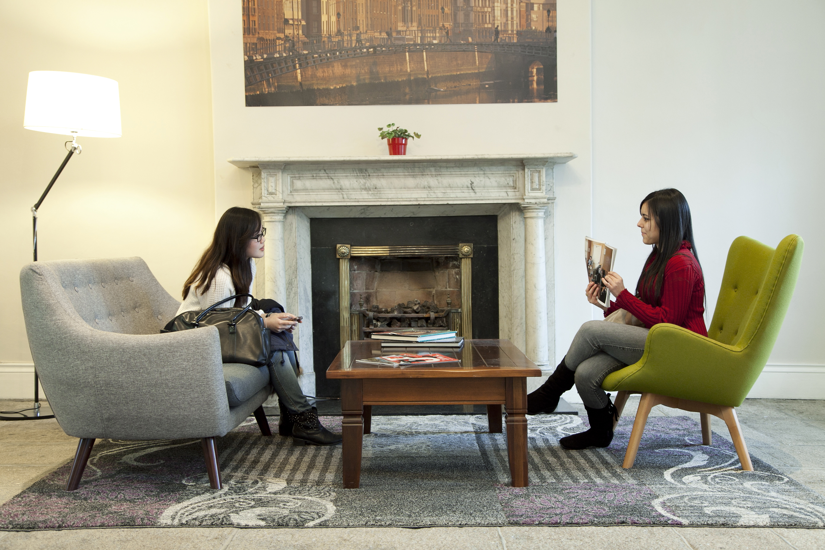 two girls reading magazines